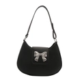 Black hobo shoulder bag with a silver metal bow accent on minimalist white background - Black