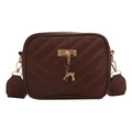 Deep brown quilted crossbody bag featuring golden deer pendant and wide shoulder strap - Brown
