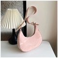 Detailed macro view of pink marble-textured leather crescent bag with gold hardware - Pink