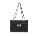 Quilted black shoulder bag featuring a silver metal bow and dual chain strap on white background - Black