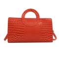 Orange handbag with crocodile pattern, ring handle, and matching shoulder strap - Orange