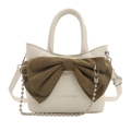 Cream bucket bag with large brown bow, metal chain strap and top handle design - White