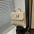 Minimalist beige crinkled leather backpack with silver butterfly buckle for women - White