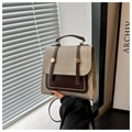 Détail du sac rétro en toile et cuir avec sangles décoratives et rivets dorés - Kaki