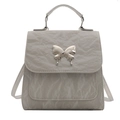 Chic light gray mini backpack with crinkled texture and silver butterfly buckle detail - Gray
