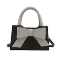 Fashionable black leather handbag with oversized silver glitter bow and top handle - Black