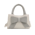 Elegant cream handbag with large silver rhinestone bow and matching glitter handle strap - White