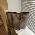 Retro canvas tote bag with brown leather handles and gold rivets in a lifestyle scene - Brown