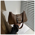 Close-up of a dark brown crescent shoulder bag with a silver buckle and leather strap - Brown