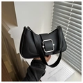 Detail shot of black baguette bag featuring a large silver square metal buckle and smooth leather - Black