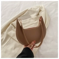 Detail of a brown PU leather crescent hobo bag with gold hardware and red lining - Khaki