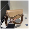 Detailed close-up of light khaki saddle bag featuring wavy flap and adjustable strap - Khaki