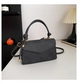 Detail of dark grey flap bag featuring decorative knotted handle and gold-tone hardware - Black
