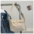 Detail of beige wrinkled fabric crossbody bag with wide adjustable strap and front pocket - Khaki
