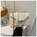 Detailed shot of white quilted flap bag with gold chain and metal buckle closure - White