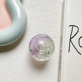Close-up of a sparkling 3D star doughnut phone socket with glitter and sequins - Purple Green (Contrasting Stars)