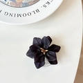 Detail of matte black floral phone socket featuring a textured golden metal center - Black
