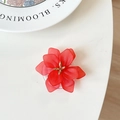 Macro shot of red flower phone stand with matte petals and golden stamen detail - Red