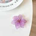 Detail shot of purple flower phone grip with matte petals and golden bead center - Purple