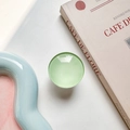 Detail of round mint green glass phone grip expanding on a stylish tray background - Light Green