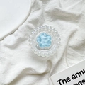 Detail von blauem Blumen-Handyhalter mit Perlenrand und Silberglitzer auf weißem Stoff - Blau