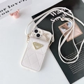 Detailed view of white quilted leather iPhone case with Luck gold plaque and Smile crystals - iPhone 15 Pro Max / Apricot