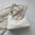 White faux leather crescent cloud bag with pleated strap and side bow detail - White
