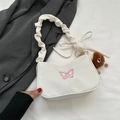 White underarm bag with pink butterfly embroidery and a plush monster charm detail - With Pendant / White