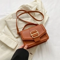 Minimalist brown pebbled leather crossbody bag with elegant gold buckle and top handle - Brown