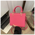 Detail view of rose red square handbag with gold hardware and stitching texture - Rose Red