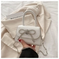 Detail of white leather mini bag with sparkling rhinestone bow and silver chain strap - White