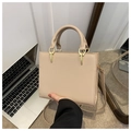 Detail shot of beige faux leather handbag with gold metal clasp and adjustable shoulder strap - Khaki