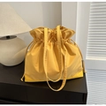 Bright yellow nylon bucket bag with drawstring closure and comfortable shoulder straps - Yellow