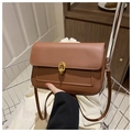 Detail of caramel leather crossbody bag with golden ring buckle and decorative stitching - Tan