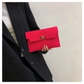 Detail of vibrant rose red crocodile embossed felt envelope clutch with gold metal buckle - Rose Red