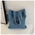 Borsa tote classica in denim blu lavato con tasca frontale su espositore minimalista - Azzurro