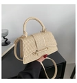 Detailed view of woven straw texture and gold metal hardware on chic beige handbag - Khaki