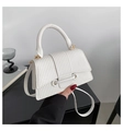 Close-up of white woven leather crossbody bag with golden hardware and top handle - White