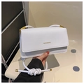 Detail view of white minimalist flap bag with gold MISSMINI logo and metal hardware - White