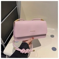 Detail view of pink flap bag featuring golden MISSMINI logo and knotted shoulder strap - Pink