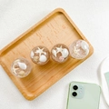 Detail showing four ocean-themed expandable phone grips with starfish and seashells - Ocean Beach Starfish Shell Crystal Ball Grip