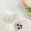 Detail of clear resin phone grip featuring pink butterfly, strawberry and glitter sequins - Starry Strawberry Butterfly - Green Daisy