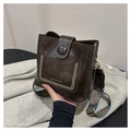 Detail of dark coffee vintage bucket bag with gold rivets and colorful geometric strap - Coffee No Charm