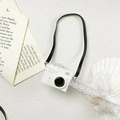 Detailed view of camera-shaped phone stand on elegant white marble with lace and shells - Transparent Bracket-Leather Camera-White