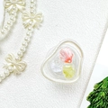 Vue détaillée du support téléphone en cœur avec incrustations de fleurs - Fleur de Coquillage Rendue - Rouge