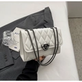 Detail of white quilted faux leather shoulder bag with dark gunmetal chain and buckle - Off White