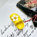 Dettaglio di uno zoccolo in EVA giallo con un grande fiore bianco e ciondolo a sorriso - Decorazione Grande Fiore Sorriso / Giallo