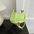 Bright green crescent underarm bag with knot strap and small pouch in indoor setting - Green