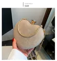 Detail of gold heart-shaped evening clutch bag with glitter finish and gem clasp - Gold