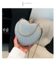 Detail of silver heart-shaped evening bag with glitter texture and gold metal handle - Silver